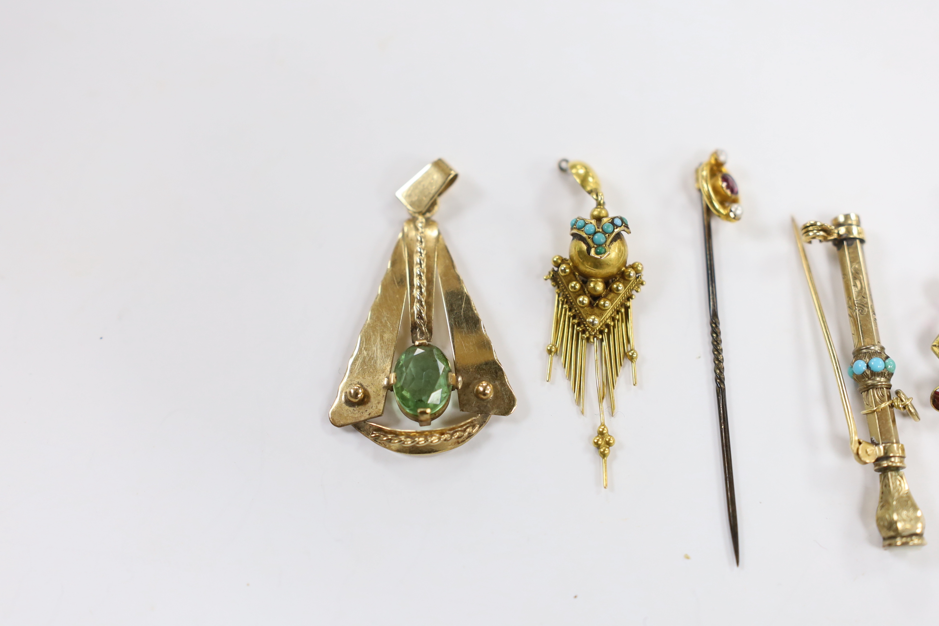 An early 20th century 9ct, garnet and seed pearl cluster set pendant, diameter 32mm, a yellow metal and gem set stylised pendant, a Victorian yellow metal and turquoise set tassel earring, a 9ct and gem set stick pin and